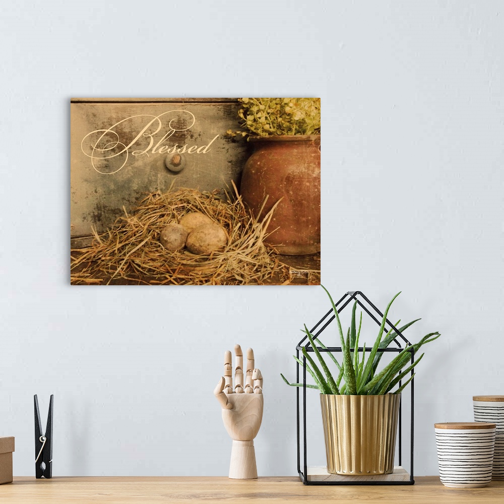 A bohemian room featuring Decorative artwork featuring eggs in a bird's nest with the word: Blessed.