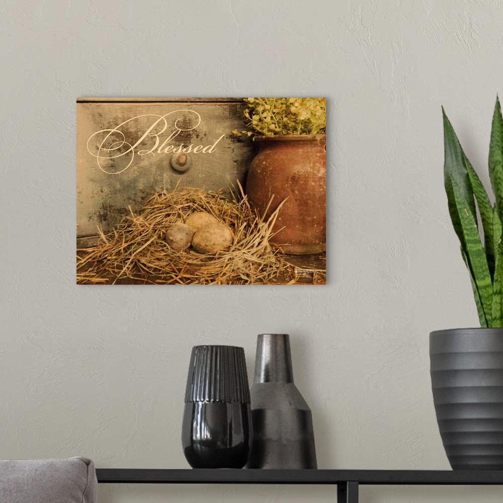 A modern room featuring Decorative artwork featuring eggs in a bird's nest with the word: Blessed.