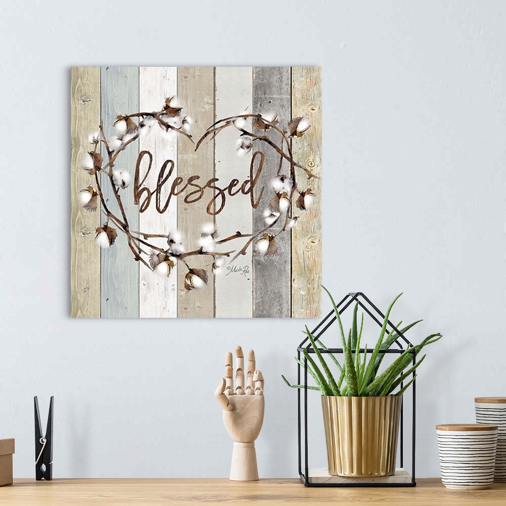 A bohemian room featuring "Blessed" in the middle of a heart wreath of cotton against a shiplap background.