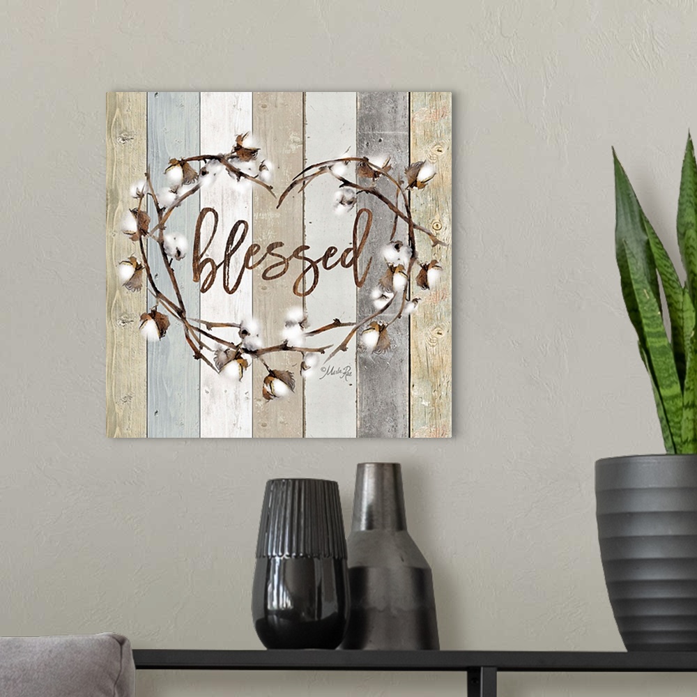 A modern room featuring "Blessed" in the middle of a heart wreath of cotton against a shiplap background.