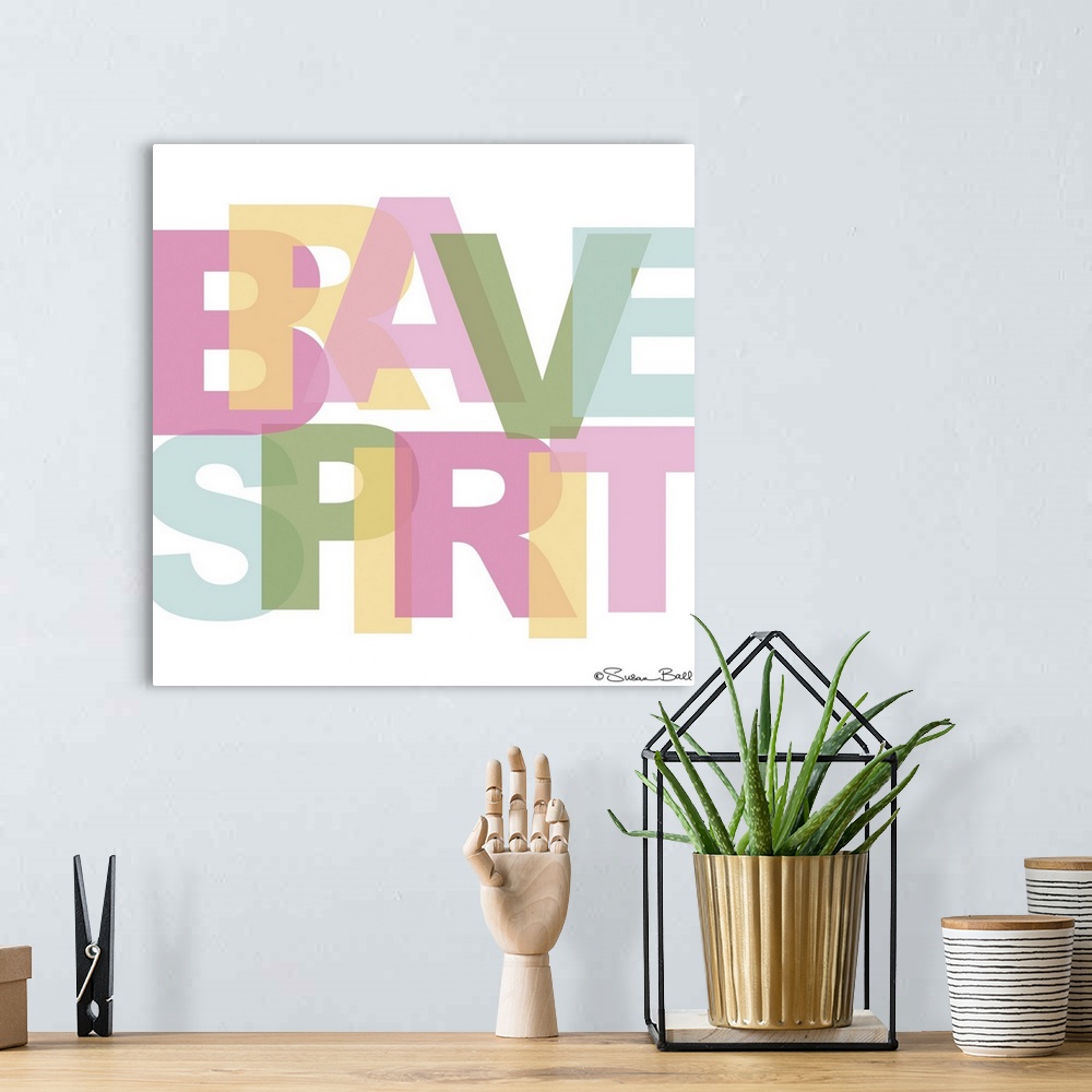 A bohemian room featuring Typography art in large, pastel block letters, overlapping on a white background.
