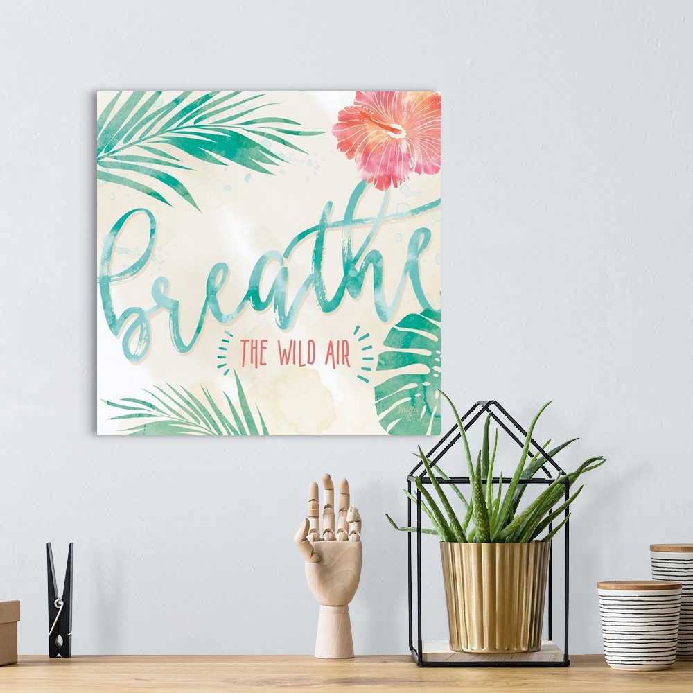 A bohemian room featuring Beach-themed artwork with "Breathe" in large script with a motif of tropical leaves and flowers.