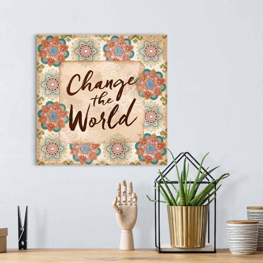 A bohemian room featuring "Change the World" hand written and framed by colorful floral mandalas.