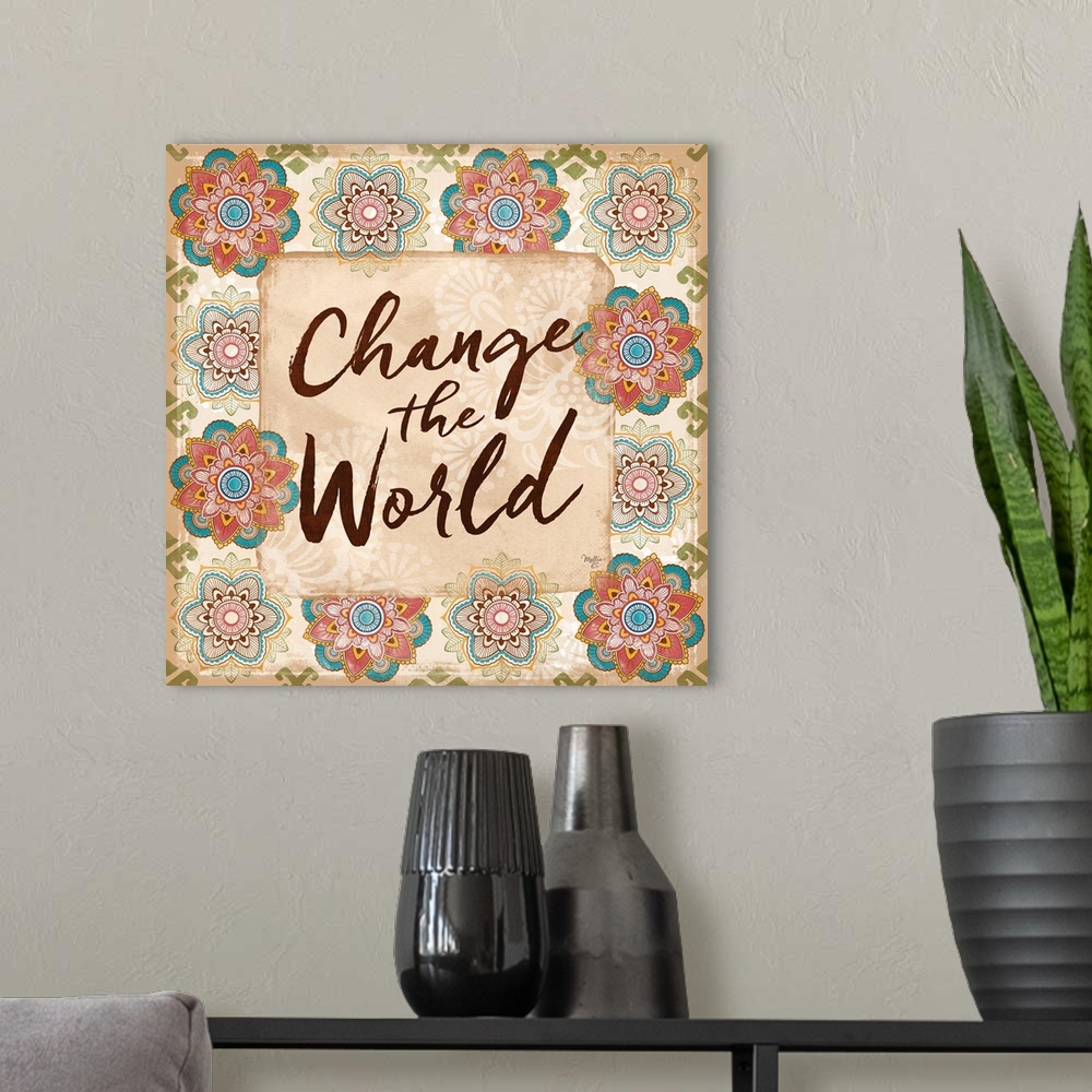 A modern room featuring "Change the World" hand written and framed by colorful floral mandalas.