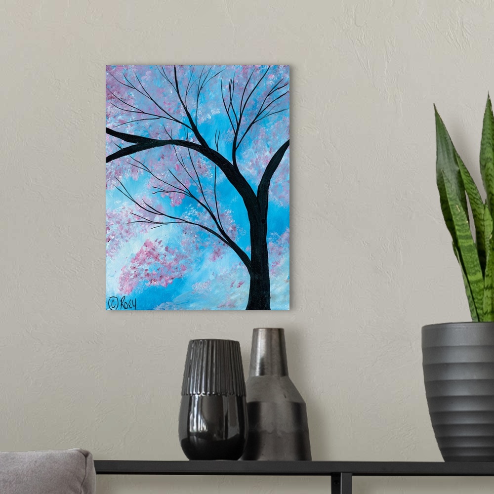 A modern room featuring Vertical contemporary painting of a Cherry Blossoms Tree surrounded by brilliant blue skies.