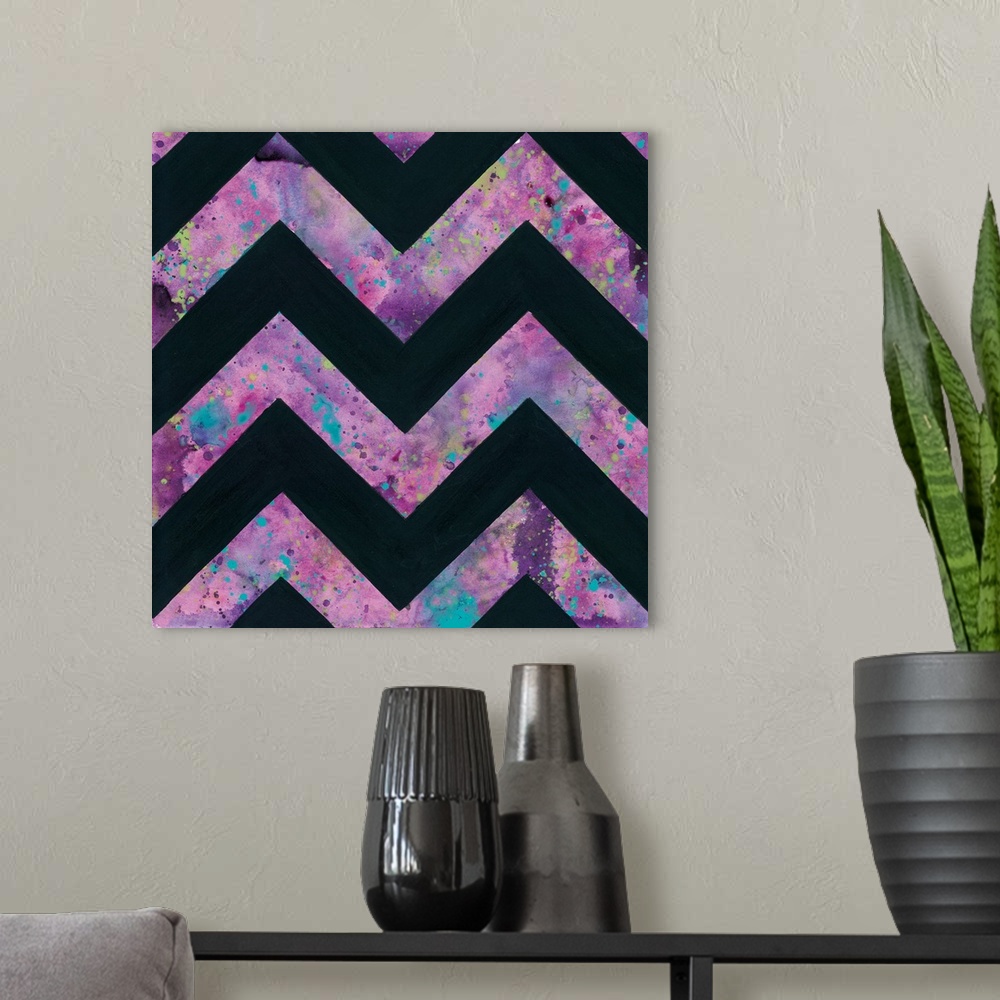 A modern room featuring Abstract art print of a chevron pattern in pink and blue contrasting with solid black.