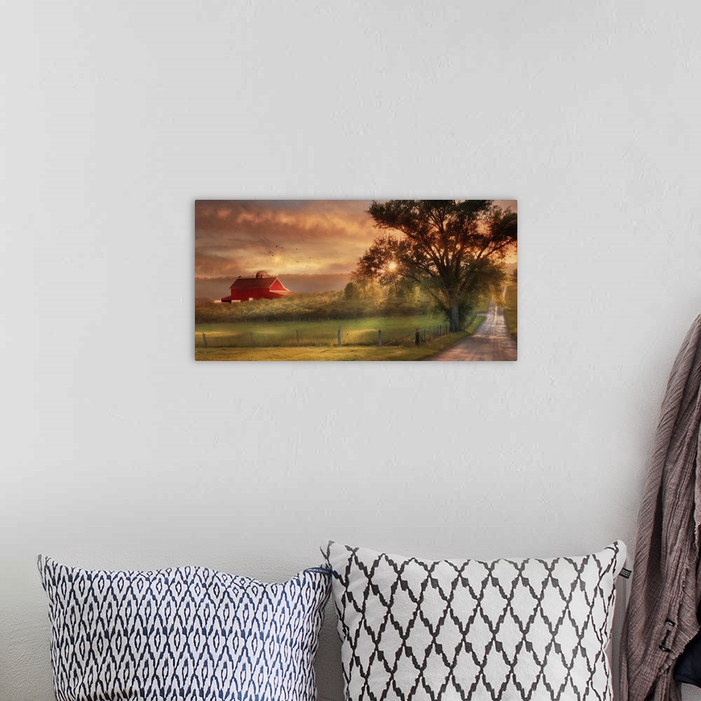A bohemian room featuring A dirt road in the countryside with a red barn in the distance at sunset.