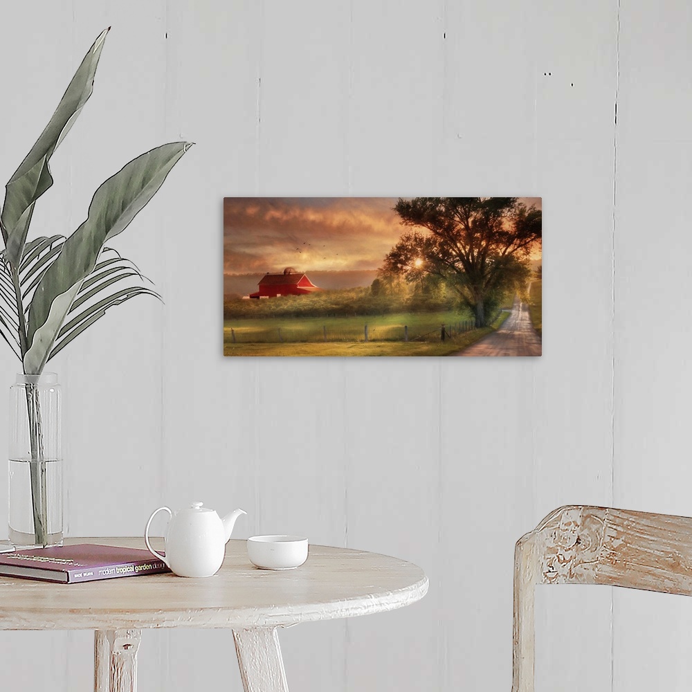 A farmhouse room featuring A dirt road in the countryside with a red barn in the distance at sunset.