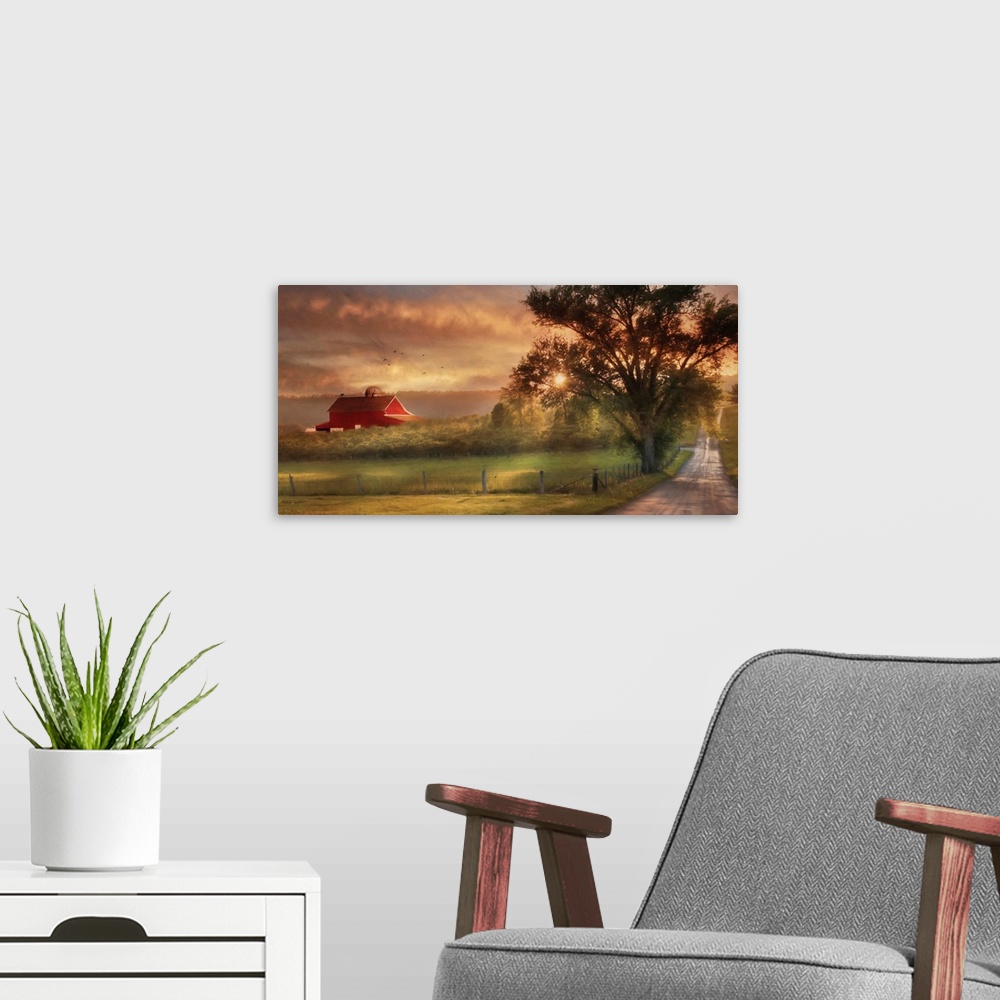 A modern room featuring A dirt road in the countryside with a red barn in the distance at sunset.