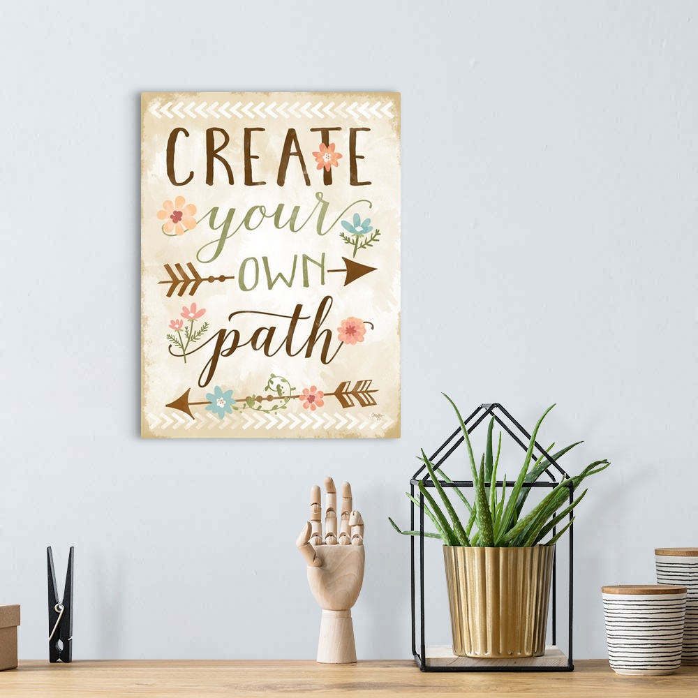 A bohemian room featuring Handlettered inspirational sentiment embellished with a tribal arrow and flower motif.