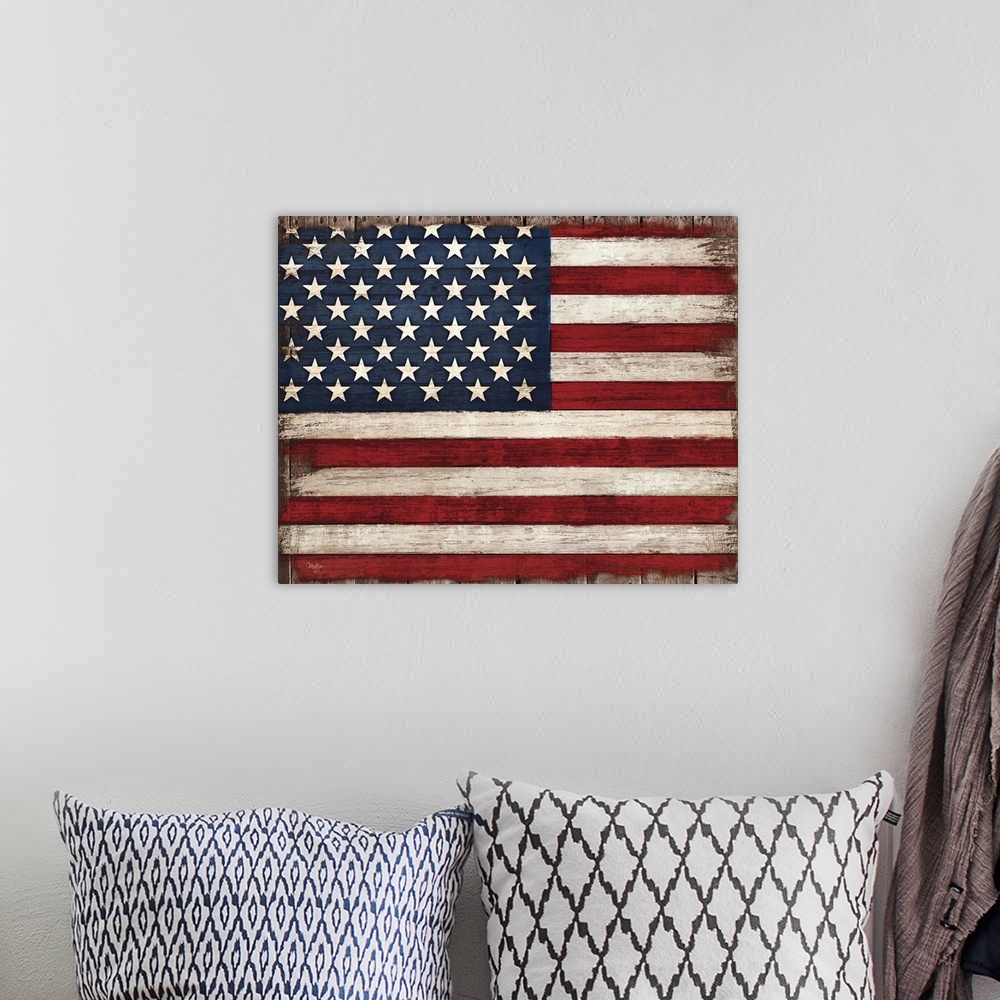A bohemian room featuring Distressed looking American flag against a rustic wooden surface.