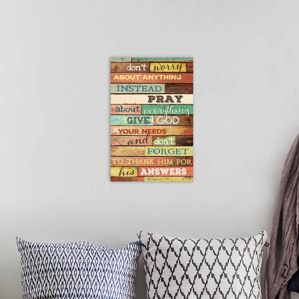 A bohemian room featuring Religious typography art against a rustic wooden surface.
