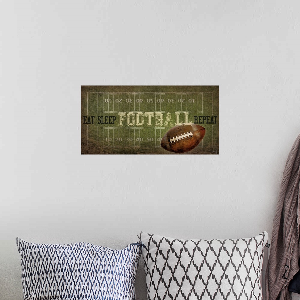 A bohemian room featuring A football typography design with the field with yardlines and a ball.