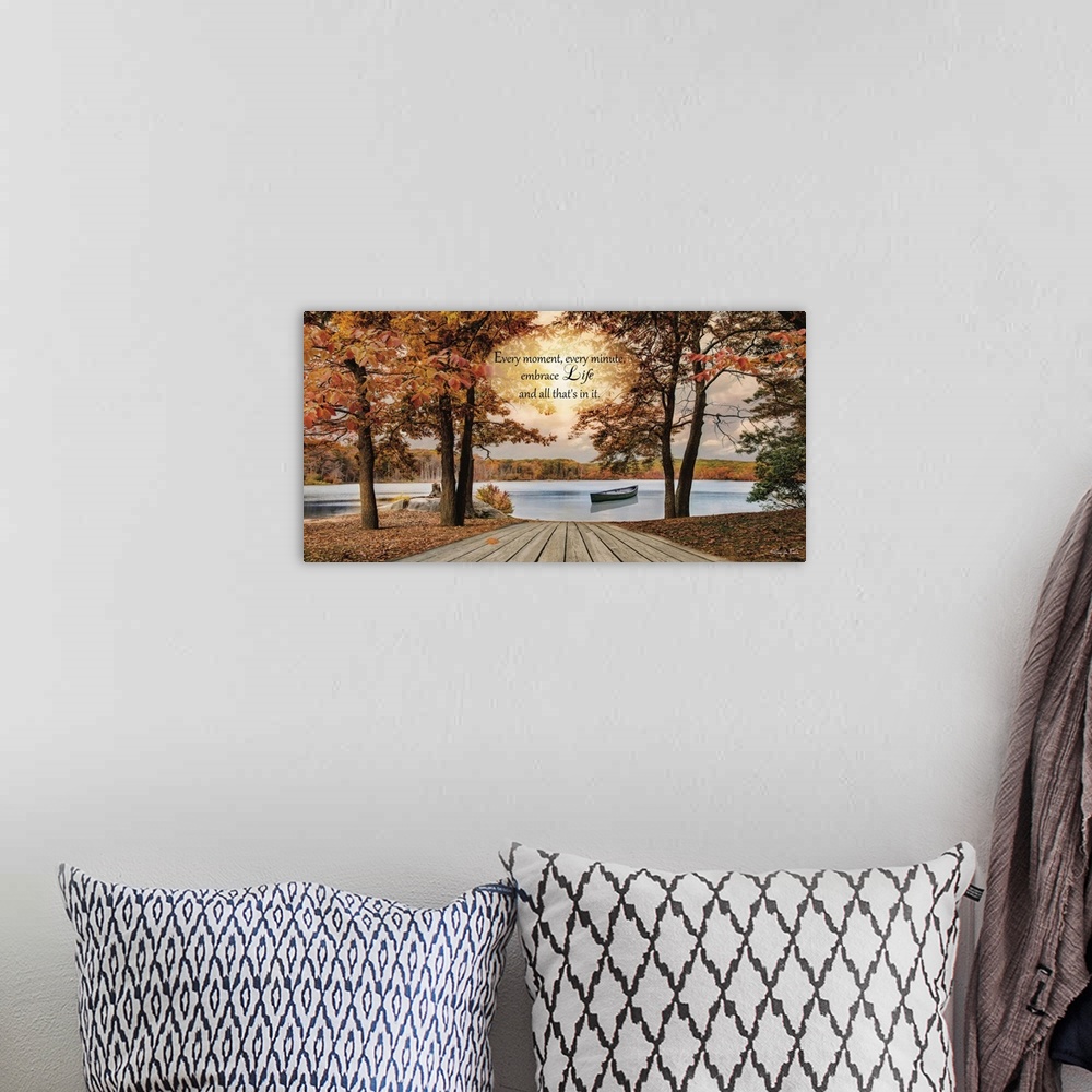 A bohemian room featuring Inspirational sentiment over an image of a lake with a canoe surrounded by trees in fall colors.