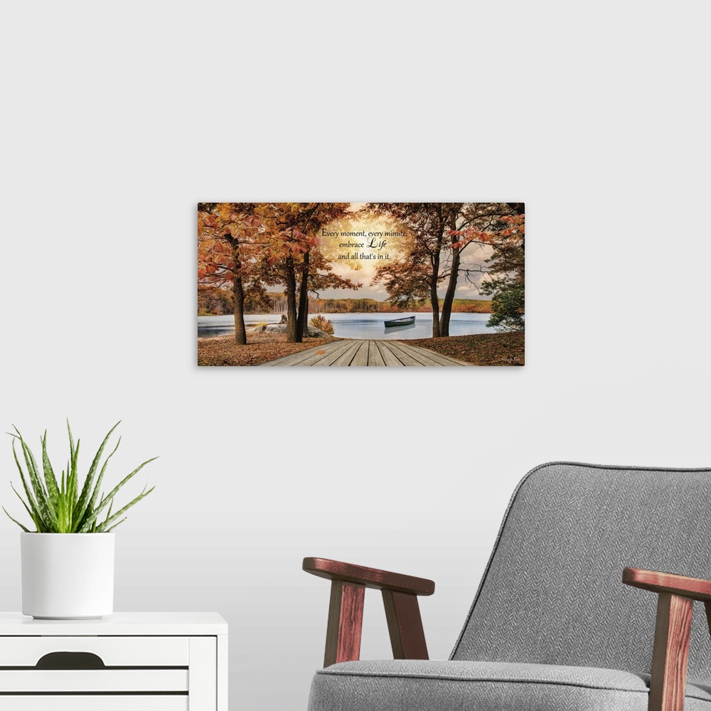 A modern room featuring Inspirational sentiment over an image of a lake with a canoe surrounded by trees in fall colors.