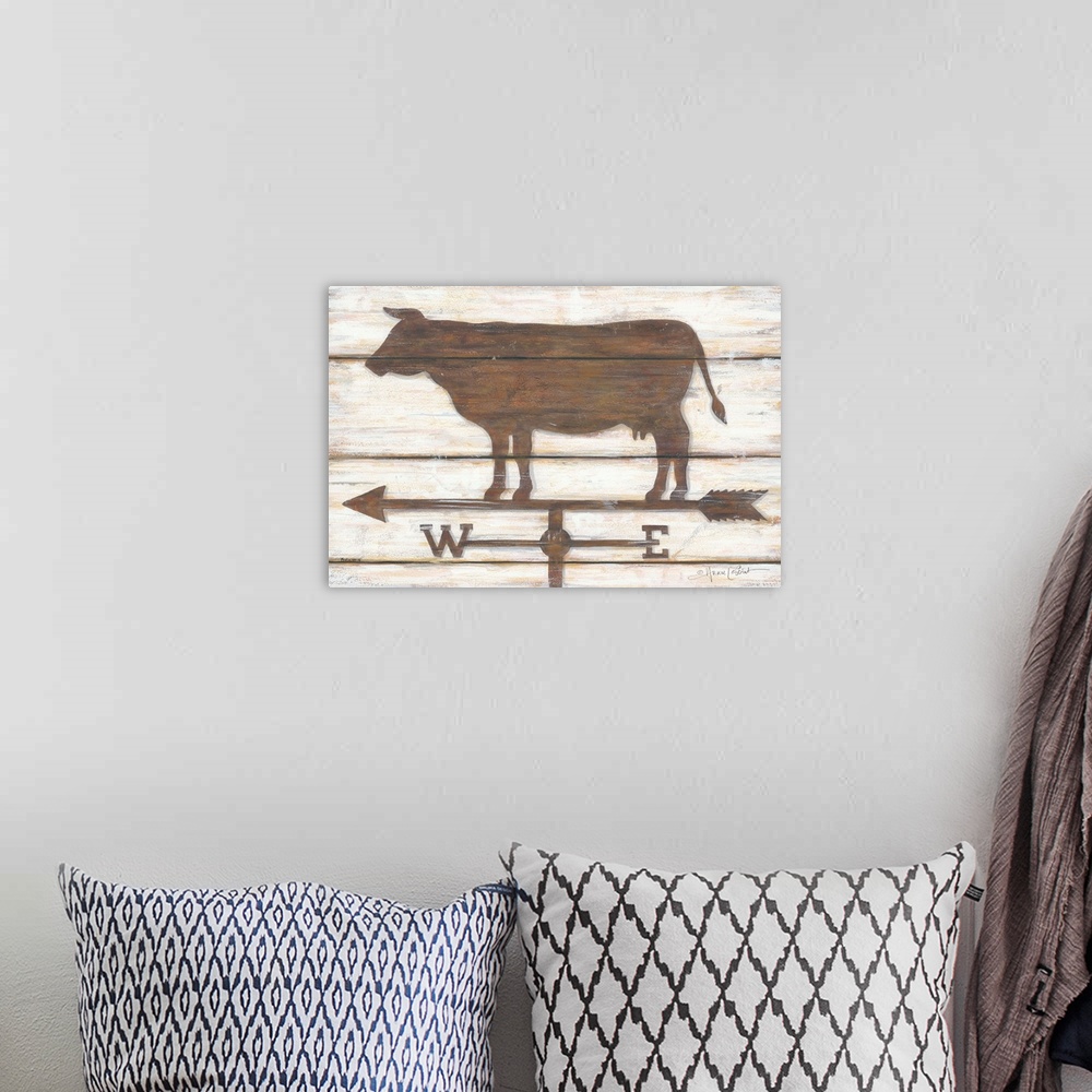 A bohemian room featuring Painted cow weather-vane on a tan background with a wooden board effect.