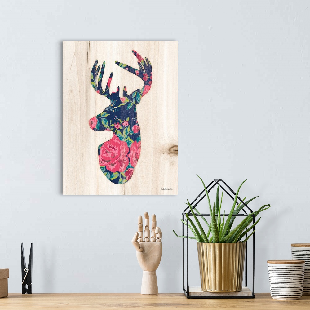 A bohemian room featuring Silhouette of a deer with a pink and navy floral motif.