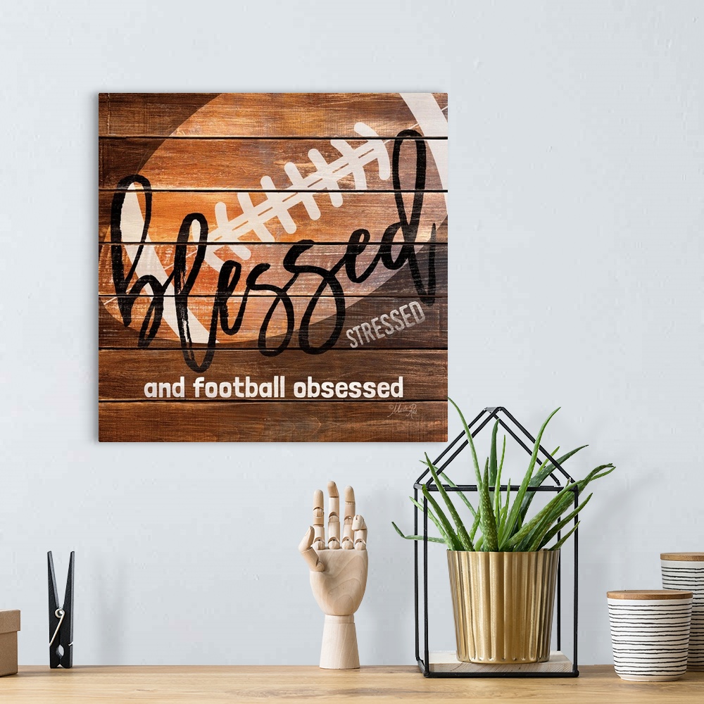 A bohemian room featuring Football themed typography art on a wooden board background.