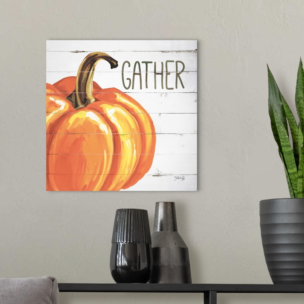 A modern room featuring Square Autumn decor with a painted pumpkin on a faux white washed wood background with "Gather" w...
