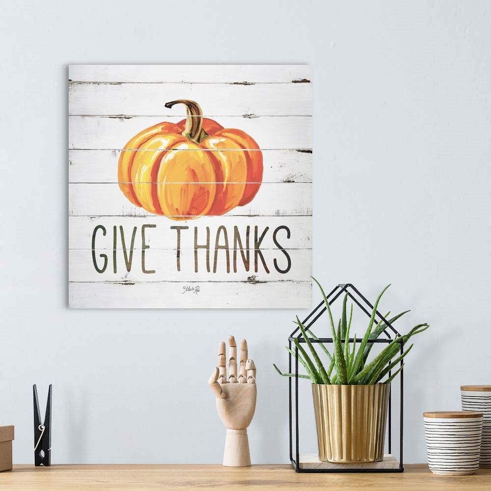 A bohemian room featuring Square Autumn decor with a painted pumpkin on a faux white washed wood background with "Give Than...