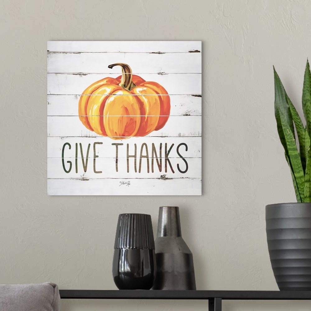 A modern room featuring Square Autumn decor with a painted pumpkin on a faux white washed wood background with "Give Than...