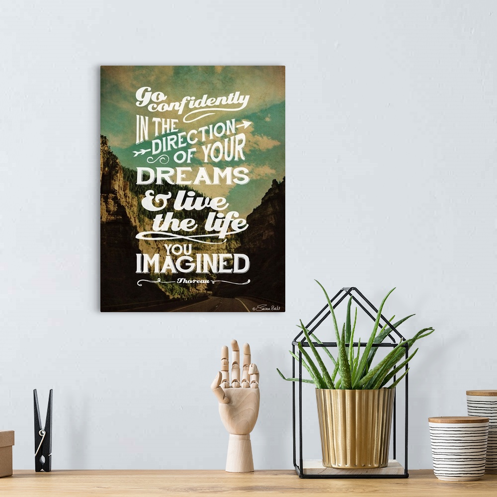 A bohemian room featuring Inspirational quote in white lettering against a photograph of a mountainous valley.