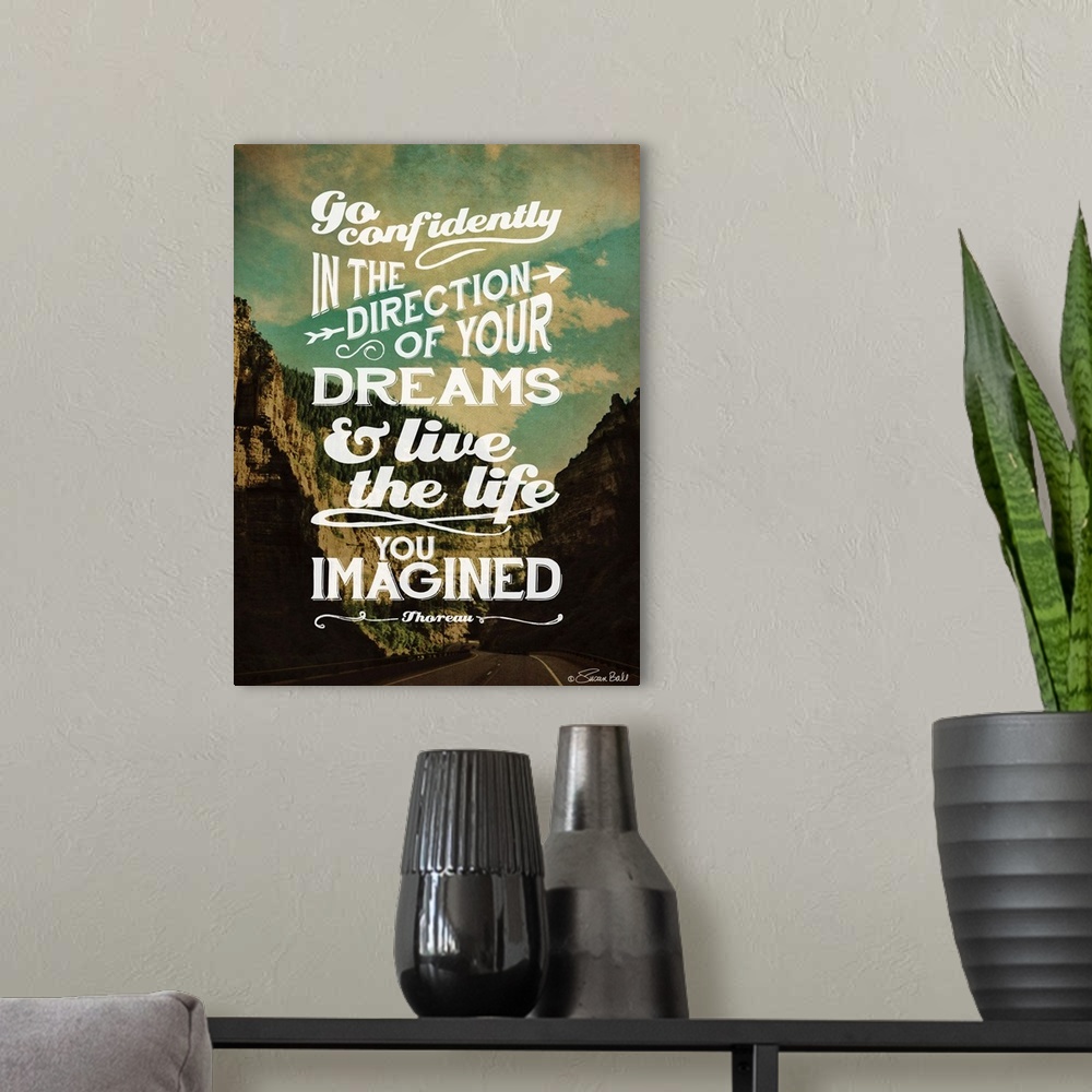 A modern room featuring Inspirational quote in white lettering against a photograph of a mountainous valley.