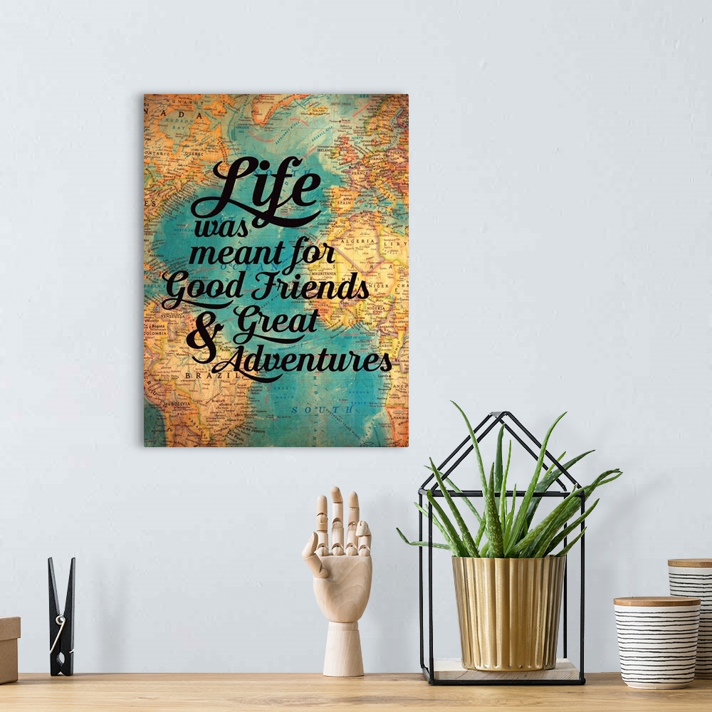 A bohemian room featuring Typography artwork of a sentiment honoring friendship over an image of an antique world map.