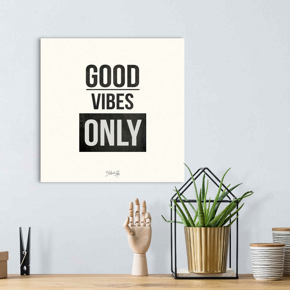 A bohemian room featuring Bold typography design in black and white which reads "Good Vibes Only."