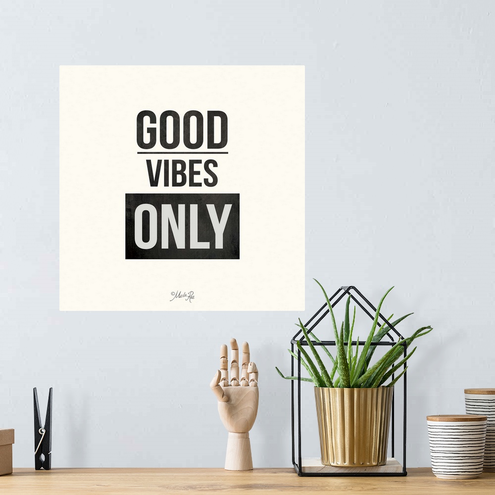A bohemian room featuring Bold typography design in black and white which reads "Good Vibes Only."