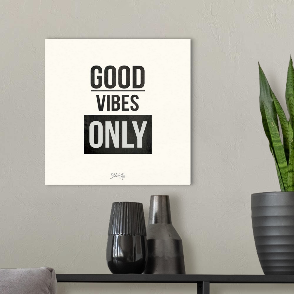 A modern room featuring Bold typography design in black and white which reads "Good Vibes Only."