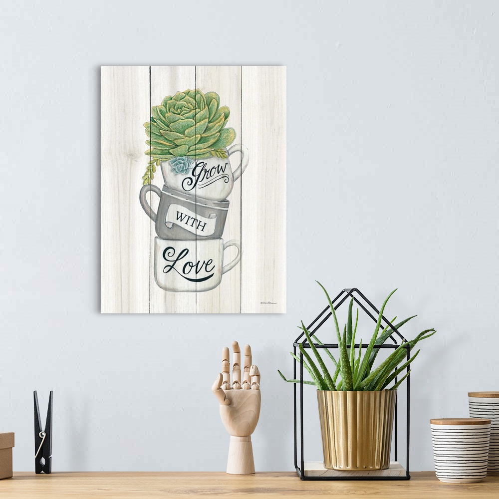 A bohemian room featuring The words, grow with love, are placed over stacked teacups with a succulent at the top.