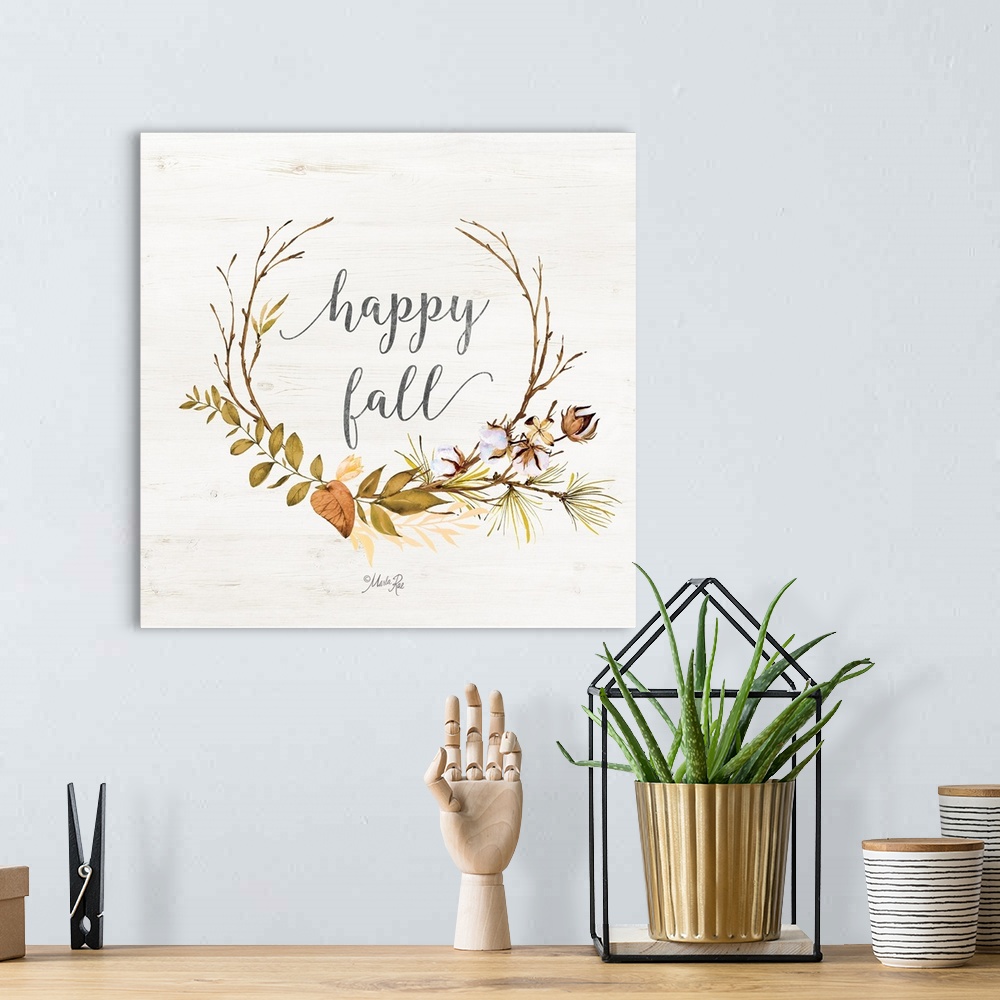 A bohemian room featuring "Happy Fall" framed with fall leafs on a white washed wood background.
