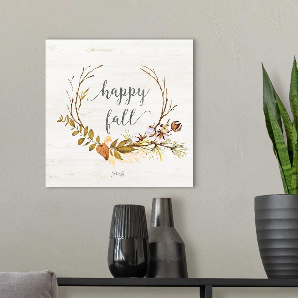 A modern room featuring "Happy Fall" framed with fall leafs on a white washed wood background.