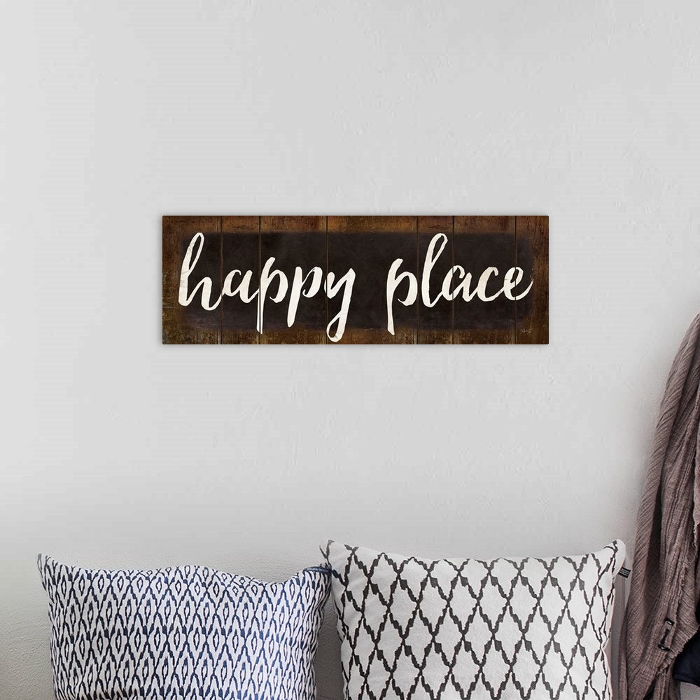 A bohemian room featuring "Happy Place" in white handlettered script on a weathered brown background.