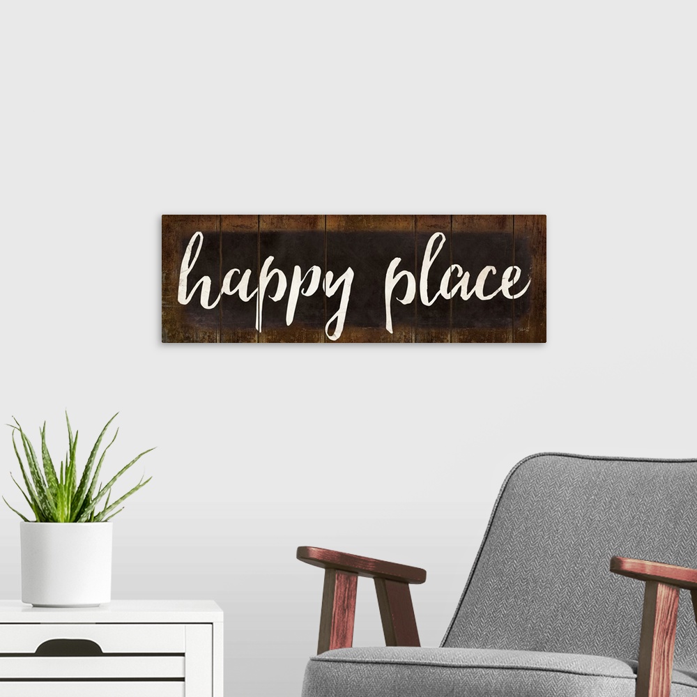 A modern room featuring "Happy Place" in white handlettered script on a weathered brown background.