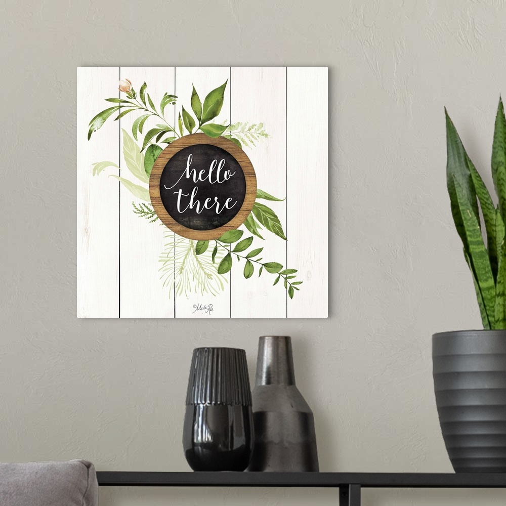 A modern room featuring "Hello There" with greenery on a white shiplap background.
