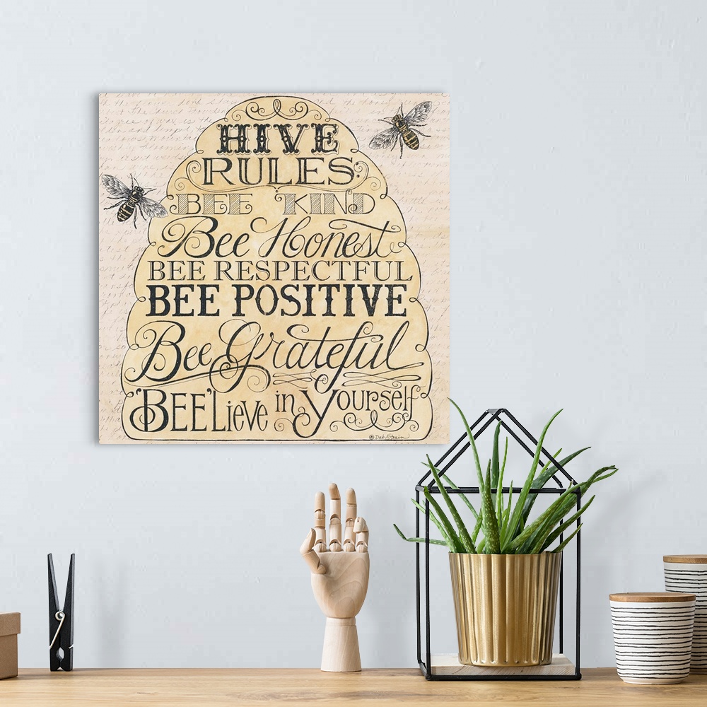 A bohemian room featuring Handlettered home decor art of bees hovering around a bee hive filled text.