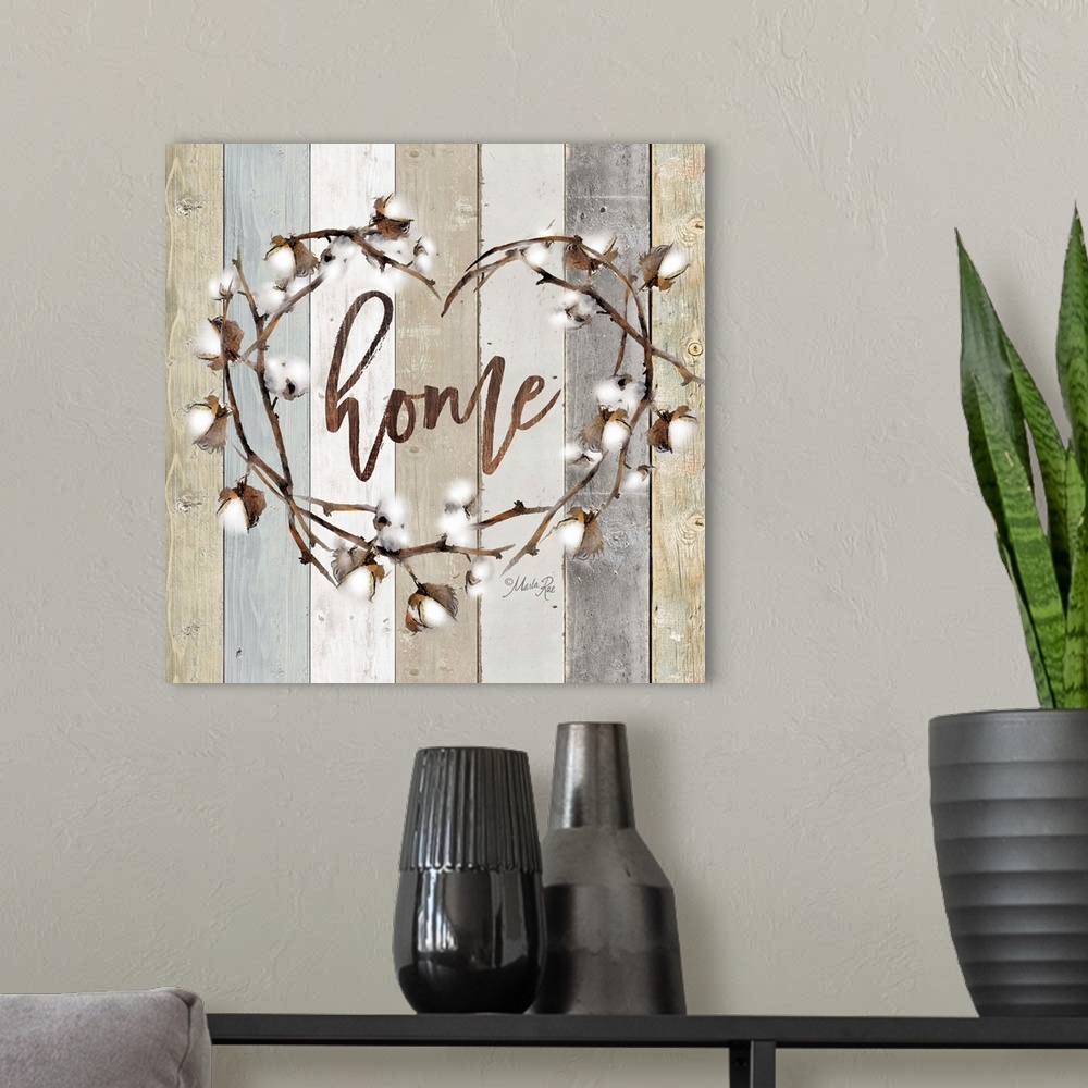 A modern room featuring "Home" in the middle of a heart wreath of cotton against a shiplap background.