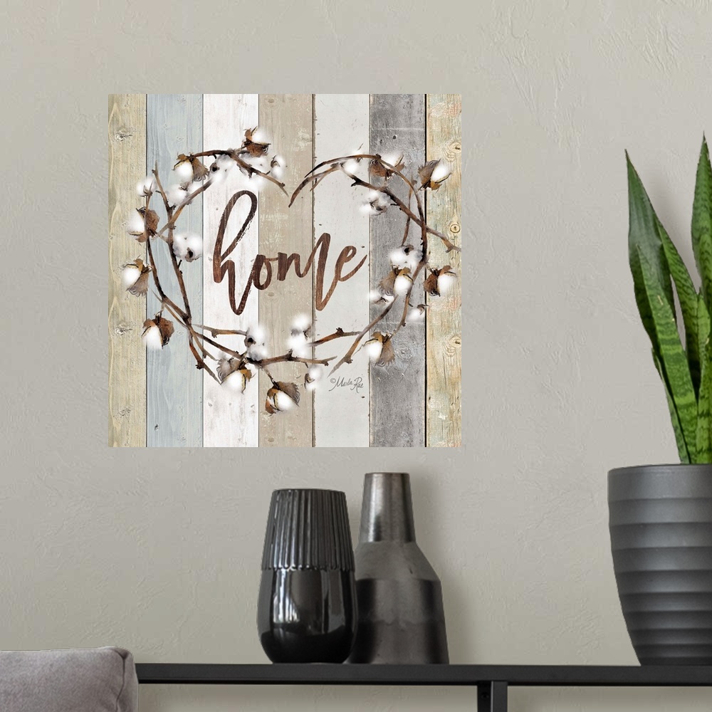 A modern room featuring "Home" in the middle of a heart wreath of cotton against a shiplap background.