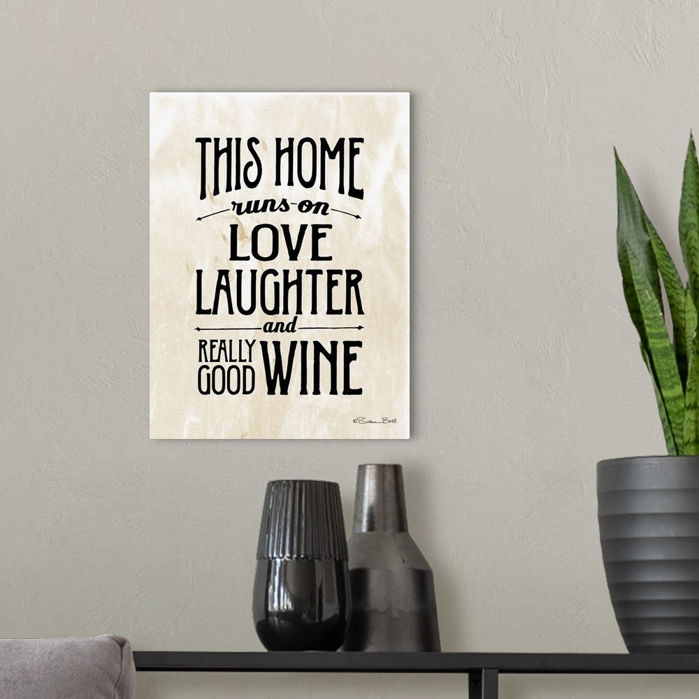 A modern room featuring Humorous artwork reading "This home runs on love, laughter, and really good wine" in black text o...