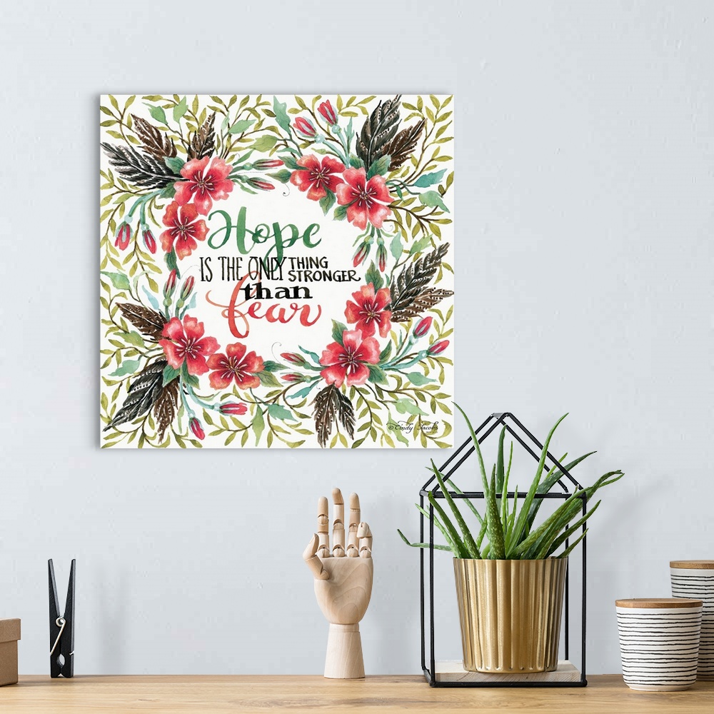 A bohemian room featuring Handlettered sentiment in a wreath of red poppies with dark leaves.
