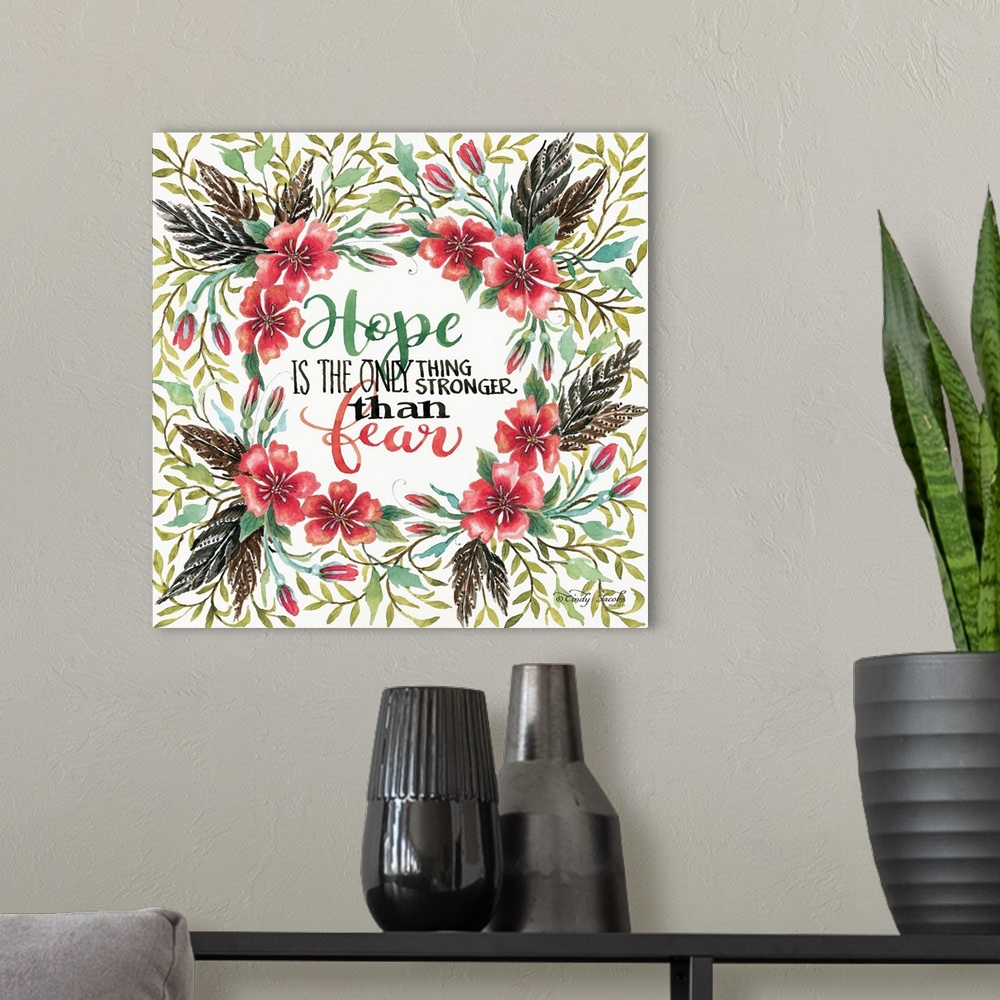 A modern room featuring Handlettered sentiment in a wreath of red poppies with dark leaves.