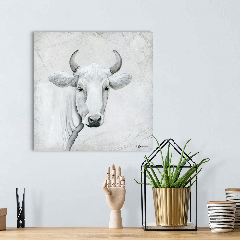 A bohemian room featuring Portrait of a white cow with curved horns.
