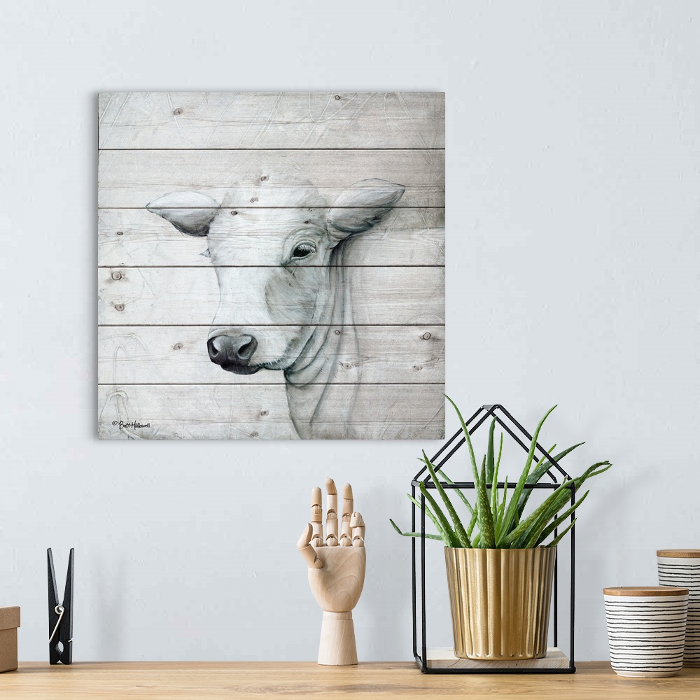 A bohemian room featuring Painting of a white cow with a quiet expression on a faux wooden board background.