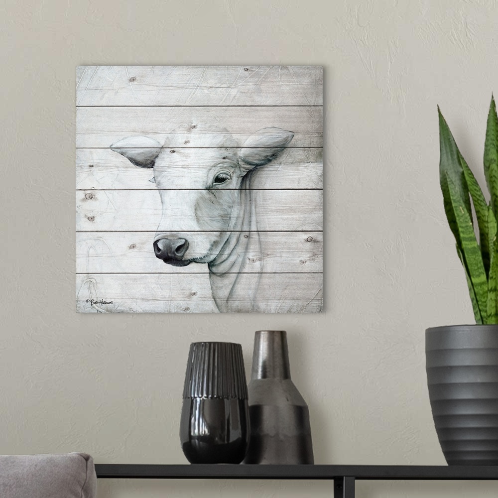 A modern room featuring Painting of a white cow with a quiet expression on a faux wooden board background.