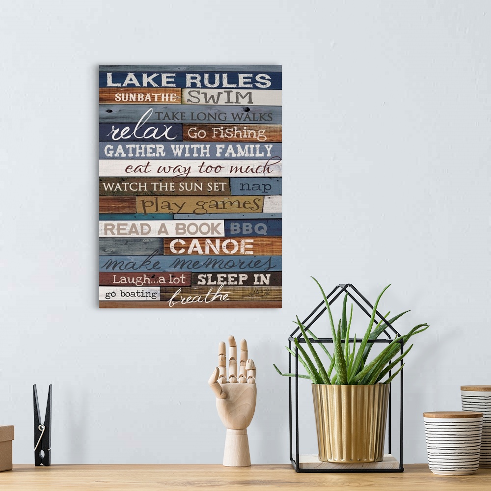 A bohemian room featuring Typography artwork of lake rules, with text against a wooden background.