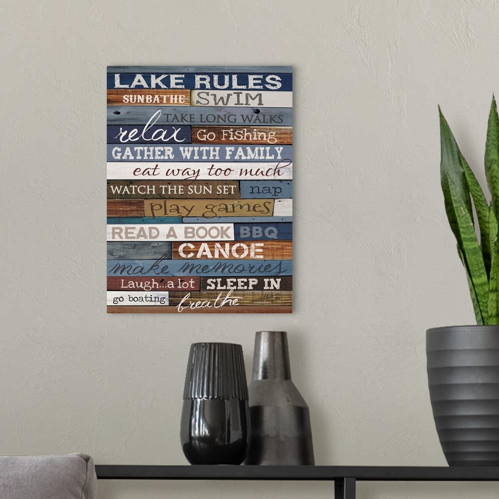A modern room featuring Typography artwork of lake rules, with text against a wooden background.