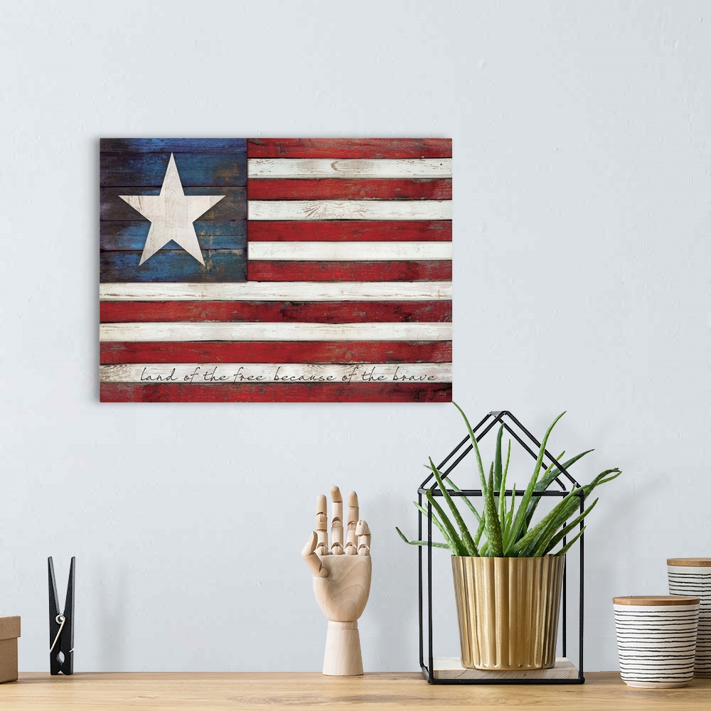 A bohemian room featuring Rustic distressed American flag with text in the white stripes painted on a wooden surface.
