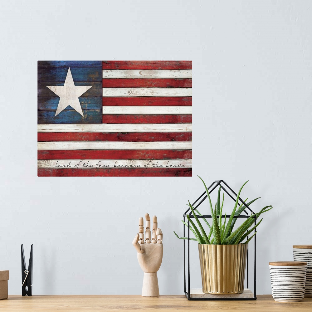 A bohemian room featuring Rustic distressed American flag with text in the white stripes painted on a wooden surface.
